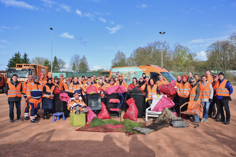 Mitarbeitende der Stadtwerke Halle zeigen nach der Putzaktion ihren gesammelten Müll.