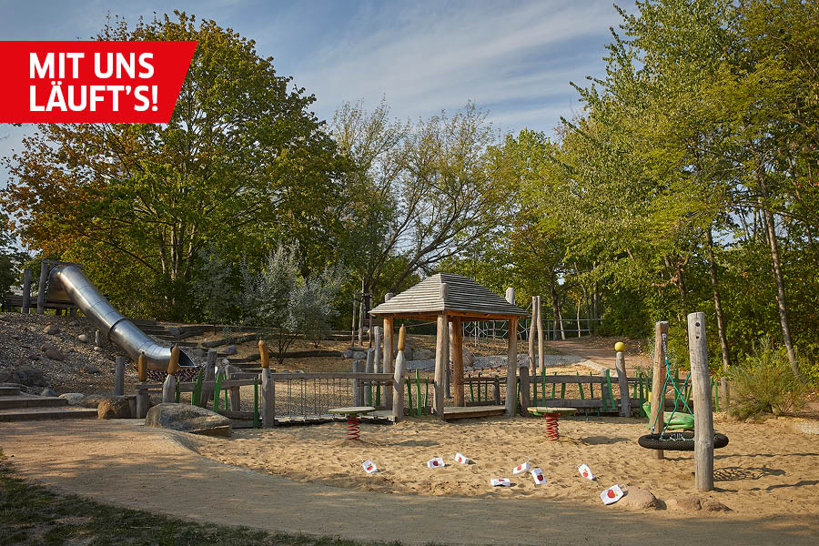 Die Sonne scheint den Spielplatz „Am kleinen Teich“ in Halle an, der auf dem Bild gezeigt wird. Plastiktrinkhalme liegen auf dem Sand herum.