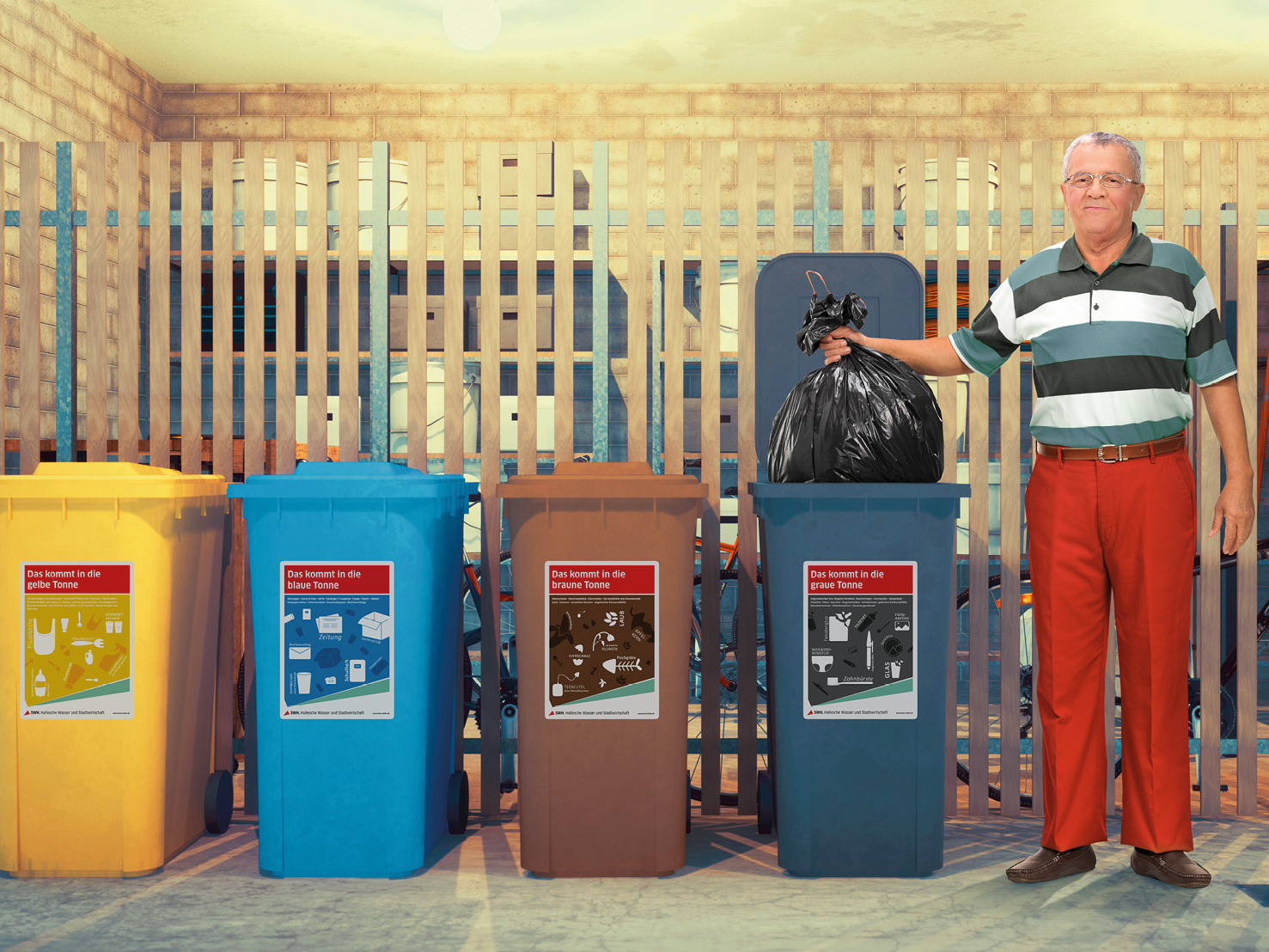 Mann neben Abfalltonnen im Keller.